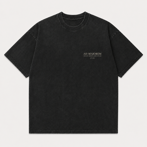 A black washed short-sleeve t-shirt with 'AD MAJOREM' printed in white on the left chest, displayed flat against a light gray background.